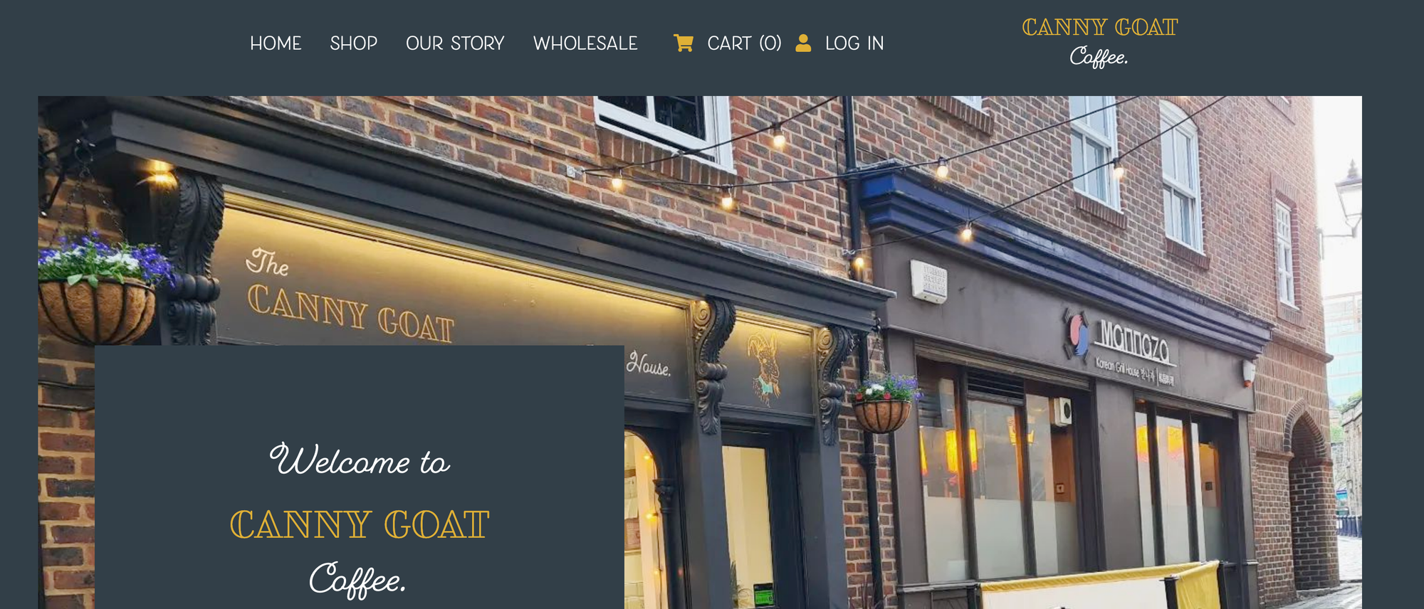 A screenshot of a webpage. The background is in dark blue and the foreground shows a photo of the cafe.
